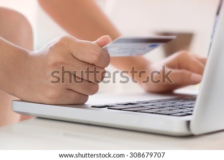 Woman hold Credit Card on laptop waiting for online shopping