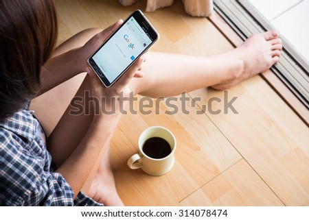 CHIANGMAI, THAILAND -SEP 6,2015:Relax time a girl touch on screen new Apple iPhone 6 Plus smartphone device open google application.