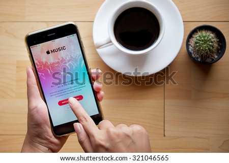 CHIANG MAI,THAILAND - SEP 16,2015 : A woman hand holding Apple music app showing on iPhone 6 plus. Apple Music is the new iTunes-based music streaming service that arrived on iPhone.
