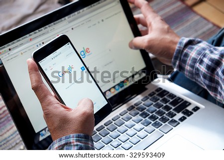 CHIANGMAI, THAILAND -OCT 20, 2015:A man touch on screen new Apple iPhone 6 Plus smartphone device open google application.