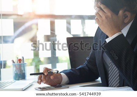 business people fail at office work,businessman hand holding his face with vintage tone and selective focus.