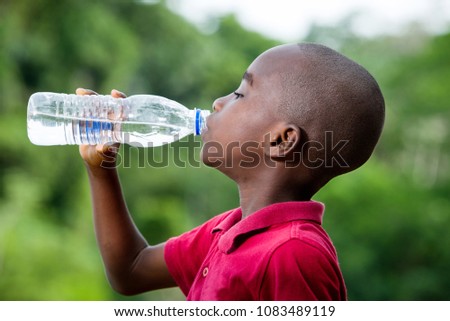 little boy drinking mineral water in nature, health concept and life of person