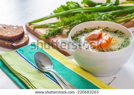 Finnish salmon soup served with bread and herbs