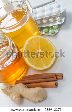 Cold care - tea, honey, lemon, ginger, cinnamon sticks, drugs, nose drops, thermometer