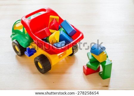 Toy car truck dumping bricks