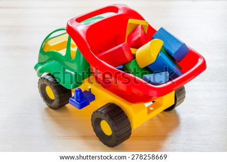 Toy car truck with bricks in vessel