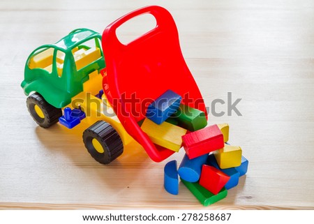 Toy car truck dumping bricks