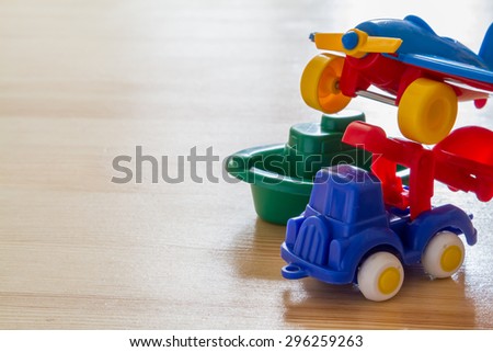 Transport infrastructure concept - toy ship, truck and plane, wood background