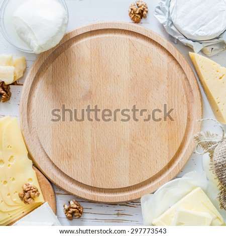 Selection of fresh dairy products - cheese, yogurt, butter, white wood background
