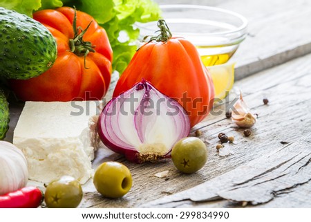 Greek salad ingredients, rustic wood background