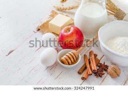 Ingredients for baking - milk butter eggs flour wheat, white wood background, copy space
