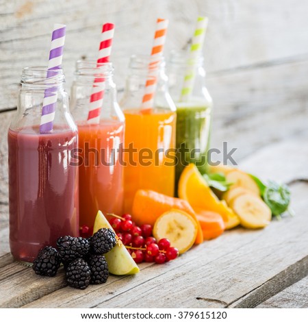 Selection of colorful smoothies, rustic wood background, copy space