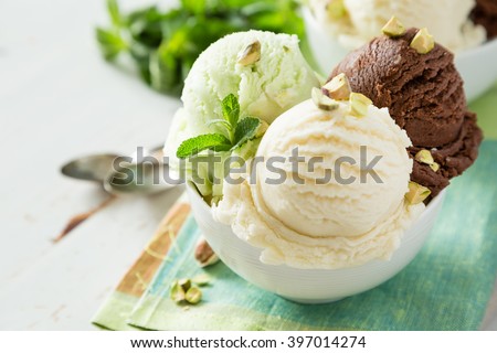 Colorful ive cream scoops in white bowl, copy space