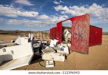 Broken appliances at the scrap metal dumpster.