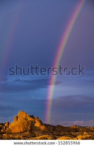 Rainbow and clearing storm over the rocks of Joshua Tree National Park.
