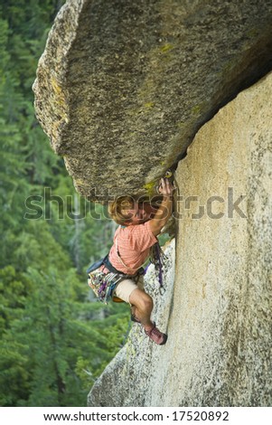 A rock climber makes his way up a crack on Suicide Rock, California, on a summer afternoon.