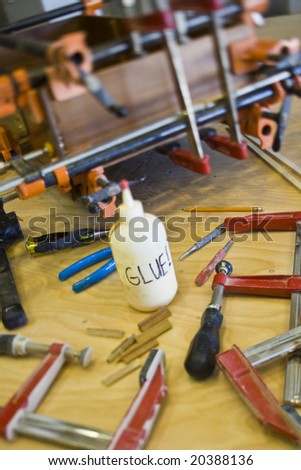 Wood working tools and glue used to repair a broken drawer.