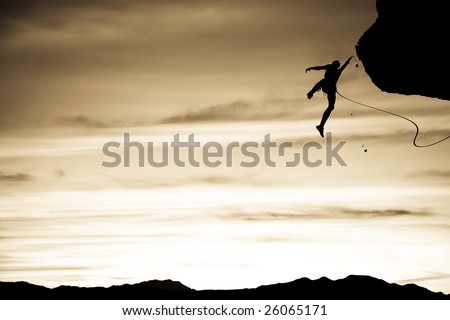 Climber in trouble clinging to a cliff for dear life in The Sierra Nevada Mountains, California.