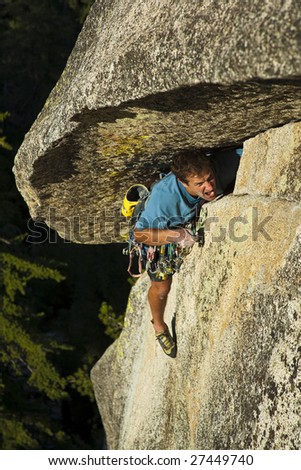 A climber grimaces as he battles his way up a strenuous crack at Suicide Rock, California.