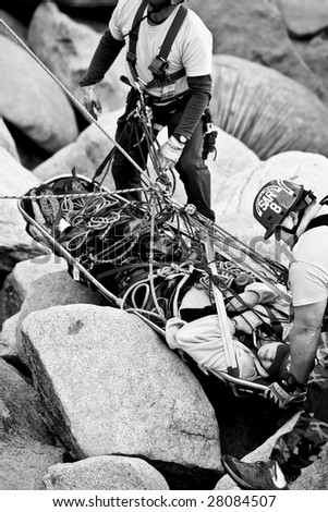 A search and rescue team preforms a high angle rescue as they evacuate an injured climber from a rock pinnacle.