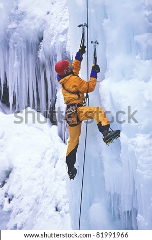 Ice climber struggles up a frozen waterfall.