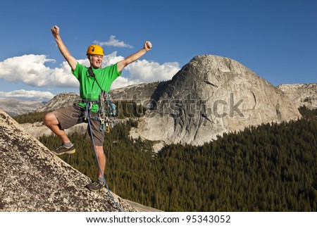 Climber celebrates on the  summit  after a successful and challenging ascent.