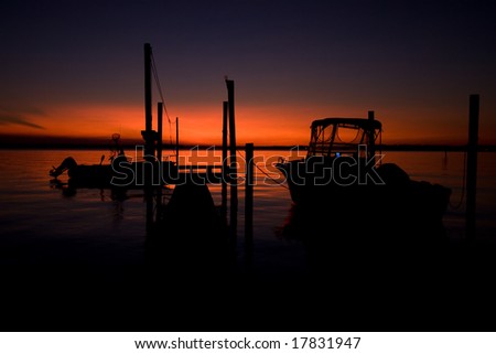 Boats silhouetted by sunset