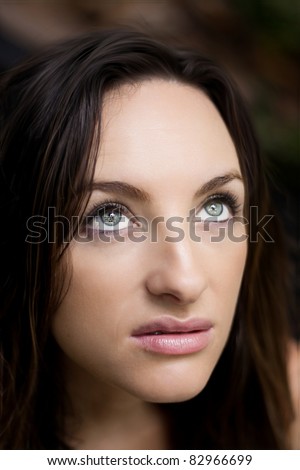 Beautiful woman with green eye looking up to the sky.
