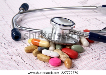 Cardiogram ekg and spilled tablets.Medical concept