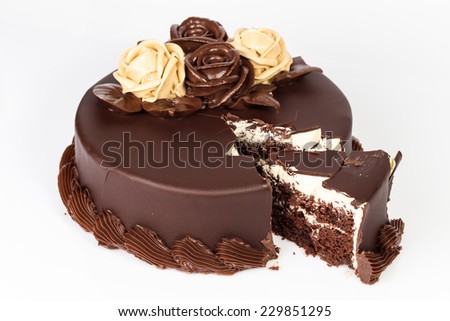 Chocolate cake with creamy roses decoration on top