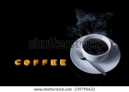 Alphabet cracker with cup of coffee with steam