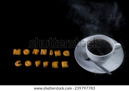 Alphabet cracker with cup of coffee with steam