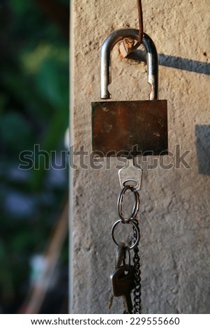 the lock and keys are hanging at the pole.