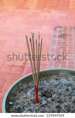 There are sticks  burning in the incense burner.