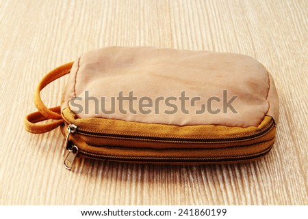 brown zipper bag which have two port.