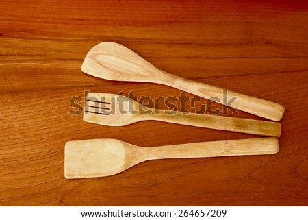 Three kitchen utensil are made from wood in dry paint