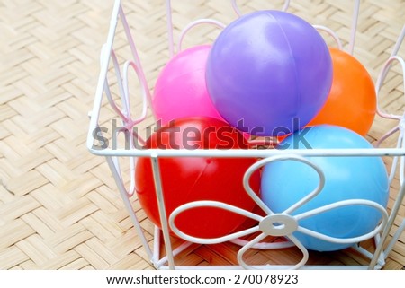 closeup image of many color balls are in steel basket in dry paint