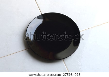 black dish put on the floor full of dust