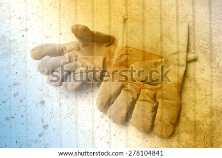 dirty leather gloves on metal sheet background