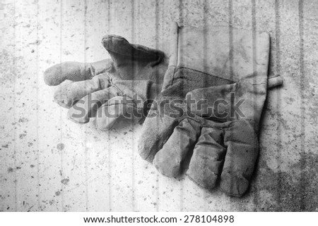 dirty leather gloves on metal sheet background