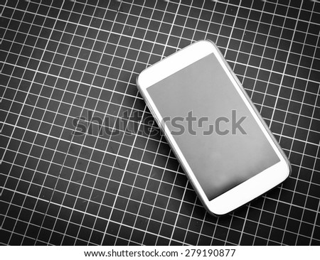 image of mobile phone put on green cutting matt in black and white tone