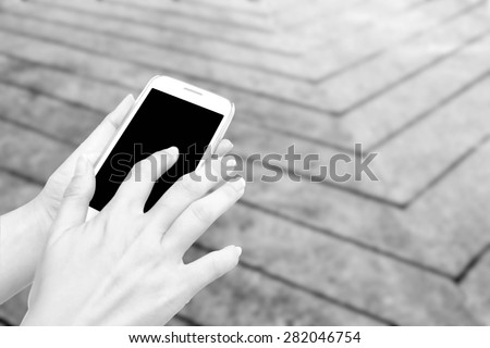 blur hand touching mobile phone on blur line concrete floor background