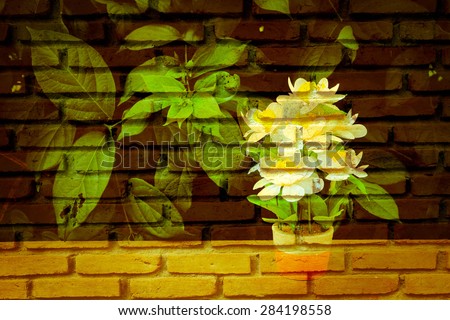 white flower vase on table with old dirty brick wall background in vintage tone
