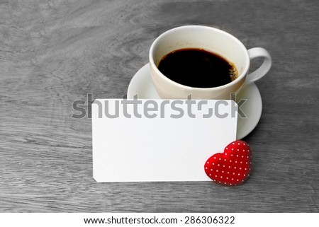 coffee and white card on table on black and white background