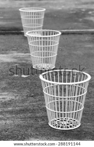 image of three baskets on wet ground in dry paint with black and white tone
