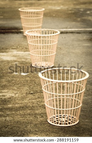 image of three baskets on wet ground in dry paint and vintage tone