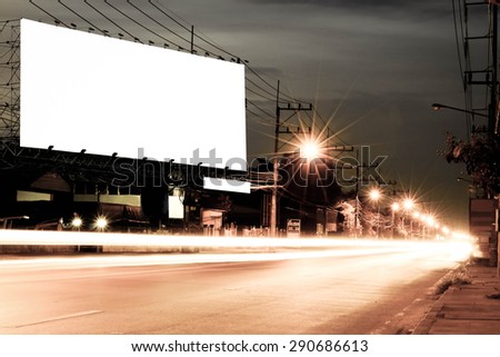 billboard at night  time with blur and flare from street light in vintage tone