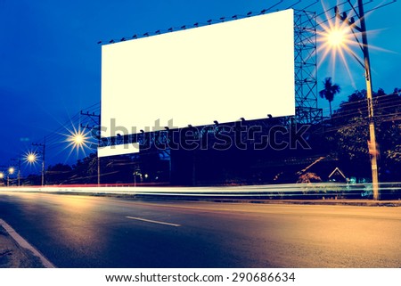 billboard at night time with blur and flare from street light