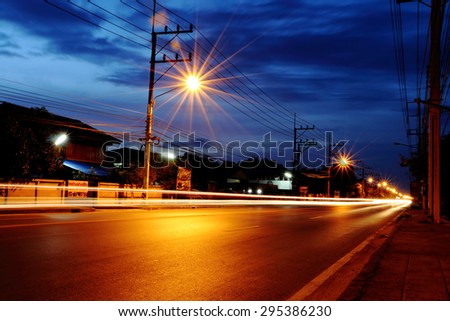 traffic light and flare beside the road in evening time