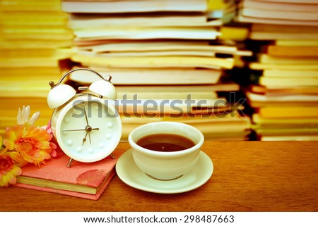 tea and flower on book with blur stacking book background